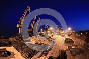 Panoramic view of the sea port cranes at night