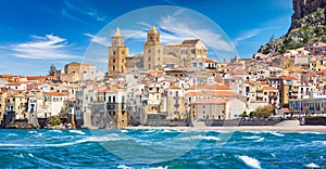 Panoramic view from sea to sandy beach in Cefalu, town in Italian Metropolitan City of Palermo located on Tyrrhenian coast of