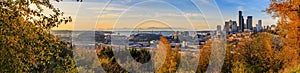 Panorama of Seattle downtown skyline at sunset in the fall with yellow foliage in the foreground from Dr. Jose Rizal Park