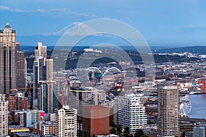 Panoramic view of Seattle skyline at blue hour from Space Needle Tower, Mt. Rainier in the background. Seattle, Washington, USA.