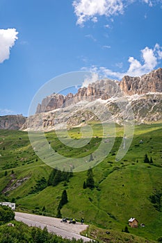 Panoramic view on the Sella massif and Piz Boe. Dolomites, Italy, Beautiful sunny summer day, green hills blue sky, vertical photo