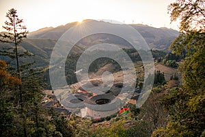 Panoramic view of the setting sun and Tianluokeng Tulou, Fujian, China