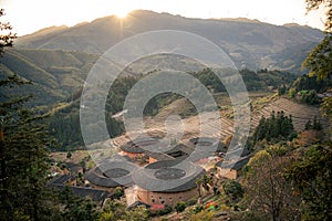 Panoramic view of the setting sun and Tianluokeng Tulou, Fujian, China