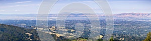 Panoramic view of Silicon Valley, with office buildings close to the bay, surrounded by residential areas; Hills and valleys in