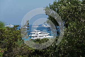 Panoramic view of small pevero beach with yacht