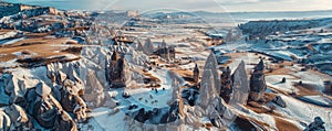 Panoramic view of snow-covered fairy chimneys in Cappadocia