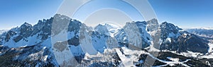 Panoramic view of snow covered mountain range against blue sky on sunny day