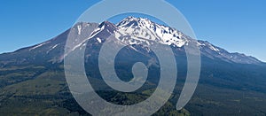 Panoramic view of the snow covered summit of Shasta mountain on a sunny summer day, California