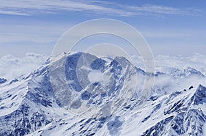 Panoramic view on snow mountain peak with clouds and blue sky, Elbrus