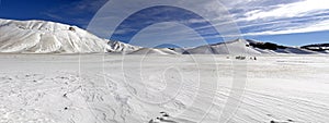 Panoramic view of snowy plateau of Castelluccio of Norcia, in Um