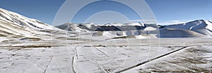 Panoramic view of snowy plateau of Castelluccio of Norcia, in Um