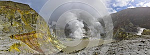 Panoramic view of steam vents and rocky hills on White Island, New Zealand`s most active cone volcano