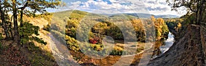 Panoramic view from steep bank of Afips river at sunset. Scenic sunny golden autumn landscape of Caucasus Mountain forest at