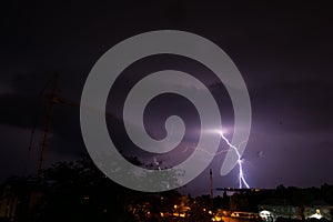 Panoramic view of a storm cloud illuminated by lightning flashes