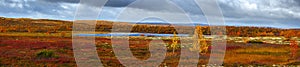 Panoramic view of storm clouds over lake in tundra in autumn. Kola Peninsula, Russia