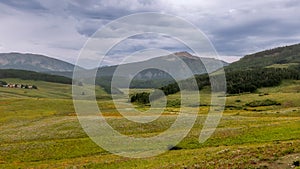 Panoramic view of summer wildflower meadow in the scenic valley near Crested Butte, Colorado on a cloudy day