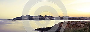 Panoramic view of sun setting over horizon at cabo de palos seascape in Murcia, Spain