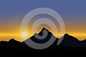 Panoramic view of the sunrise over the mountain landscape under blue sky