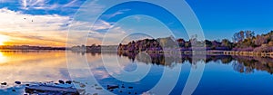 Panoramic view of sunset with beautiful skyline over lake Zorinsky Omaha Nebraska