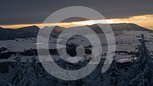 Panoramic view of sunset from Borowa Gora view point during winter time. Frosty structure, glazed, icy branches.