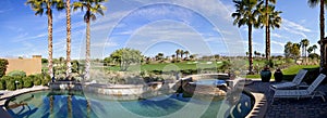 Panoramic view of swimming pool, hot tub and golf course