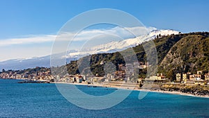 Taormina shore at Ionian sea with Giardini Naxos and Villagonia towns and Mount Etna in Messina region of Sicily in Italy