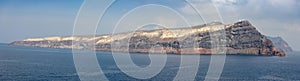 Panoramic view of Thirasia from sea next to Santorini, Greece