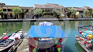 Panoramic view of the Thu Bon river as it passes through Hoi An with the boats decorated with