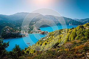 Panoramic view to Assos village Kefalonia. Greece. Beautiful turquoise colored bay lagoon water surrounded by pine and