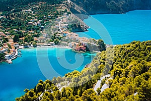 Panoramic view to Assos village Kefalonia. Greece. White lonely yacht in beautiful turquoise colored bay lagoon water