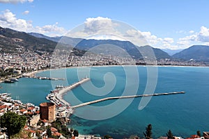 Panoramic view to the city of Alanya, marina, sea and mountains from the top of the fortress wall