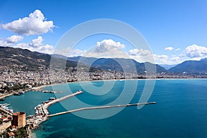 Panoramic view to the city of Alanya, marina, sea and mountains from the top of the fortress wall