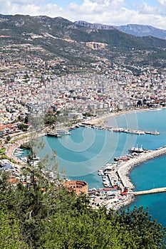 Panoramic view to the city of Alanya, marina, sea and mountains from the top of the fortress wall