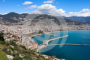 Panoramic view to the city of Alanya, marina, sea and mountains from the top of the fortress wall