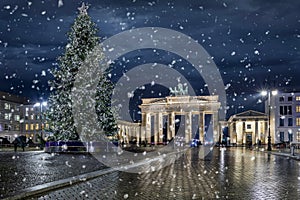 Panoramic view to the famous Brandenburg Gate in Berlin, Germany, with a illuminated christmas tree