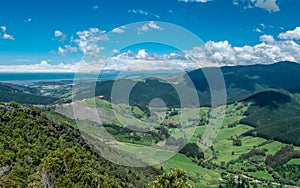 Panoramic view to green fields, hills and ocean. Nelson area, New Zealand