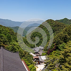 Panoramic view to Korean Buddhist Temple Complex Guinsa with valley and mountains on a clear sunny day. Guinsa, Danyang Region,