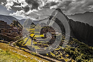 Panoramic view to old Inca ruins and Wayna Picchu with grey clou