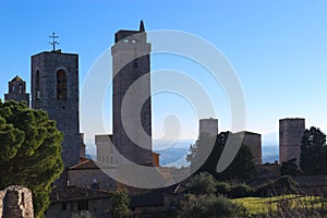 Panoramic view to San Gimignano old town with medieval towers at winter sunny day, Tuscany, Italy
