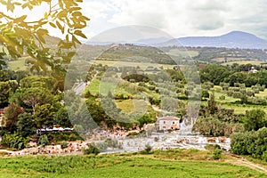 Panoramic view to Saturnia spa town with hot spring and waterfall at Cascate del Mulino (Mill waterfalls) photo