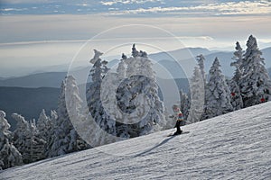 Panoramic view to the ski slopes with skiers from the Octagon cafe observation deck