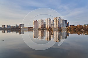 Panoramic View to the west of Krasnodar from the Kuban River in the winter at golden hours. New high-rise buildings and their refl