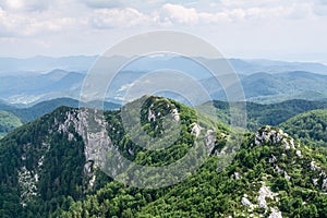 Panoramic view from the top of mountain to many mountain peaks around