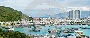 Panoramic view of tourist city of Nha Trang off coastline with fishing boats. Khanh Hoa province, Viet Nam.