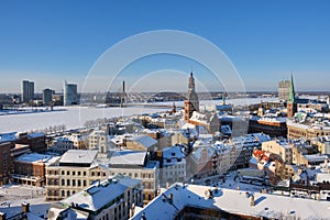 Panoramic view from tower of Saint Peters Church on Riga Cathedral and roofs of old houses in old city of Riga, Latvia in winter