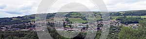 Panoramic view of the town of mytholmroyd from above with buildings and streets of the town visible in the valley