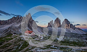 Panoramic view of Tre Cime and rifugio hut before sunrise in summer, Tre Cime di Lavaredo National Park, Dolomites, Italy