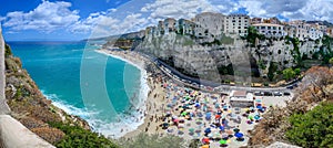Panoramic view of Tropea â€“ city on cliff with crowded beach and azure sea Calabria, ITALY