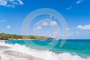 Panoramic view of tropical Red sand beach and blue water against sky