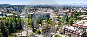 Panoramic view of UC Berkeley on a sunny day, view towards Oakland and the San Francisco bay shoreline in the background,